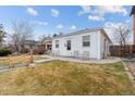 White bungalow home with a patio and small front yard at 2229 S Bannock St, Denver, CO 80223