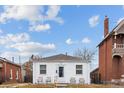 White bungalow home with a small front yard at 2229 S Bannock St, Denver, CO 80223