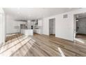 Bright kitchen with white cabinets, island, and light wood floors at 39701 Congress Ln, Elizabeth, CO 80107