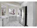 Bright kitchen with stainless steel appliances and geometric tile floor at 2511 S Clarkson St, Denver, CO 80210