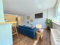 Bright living room featuring a comfy blue sofa and large windows at 1196 N Grant St # 112, Denver, CO 80203