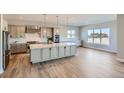 Large kitchen island with granite countertops and modern cabinets at 492 Agoseris Way, Castle Rock, CO 80104