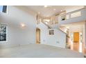 High-ceilinged living room with a staircase and lots of natural light at 22141 Chippewa Ln, Golden, CO 80401