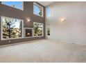 Spacious living room with a fireplace and large windows offering scenic views at 22141 Chippewa Ln, Golden, CO 80401