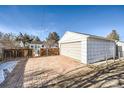 Detached single-car garage with brick driveway at 1340 Clinton St, Aurora, CO 80010