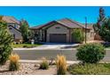 Charming home with a 2-car garage and manicured lawn at 7144 Galaxy Ct, Castle Rock, CO 80108