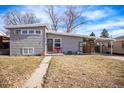 Gray ranch style home with landscaped lawn at 1654 S Perry St, Denver, CO 80219