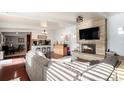Spacious living room with a fireplace and hardwood floors at 1654 S Perry St, Denver, CO 80219
