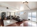 Living room with hardwood floors and large sectional sofa at 1654 S Perry St, Denver, CO 80219