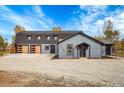 House exterior with attached garage at 14405 County Road 12, Fort Lupton, CO 80621