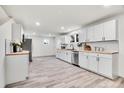 Modern kitchen with white cabinets and butcher block counters at 14405 County Road 12, Fort Lupton, CO 80621