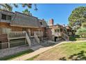 Townhouse style building, brick exterior with wooden accents at 5401 E Warren Ave # 204, Denver, CO 80222