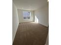 Spacious bedroom with plush carpeting and large window at 5115 N Quemoy St, Aurora, CO 80019