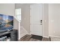 Bright entryway with stairs leading upstairs, and neutral color palette at 12772 Boggs St, Parker, CO 80134