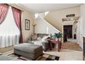 Living room with couch, ottoman, and window at 14389 E 101St Pl, Commerce City, CO 80022