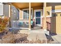 Covered front porch with seating area at 14389 E 101St Pl, Commerce City, CO 80022