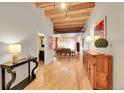 Long hallway with hardwood floors, exposed beams, and access to dining area at 1792 Wynkoop St # 303, Denver, CO 80202