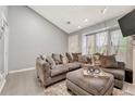 Open living area with L-shaped sofa and large window at 1148 S Ventura Cir # E, Aurora, CO 80017