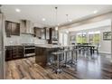 Spacious kitchen with island, stainless steel appliances, and granite countertops at 7865 S Grand Baker St, Aurora, CO 80016