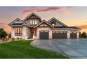 Luxury craftsman home with stone accents and a three-car garage at 6551 S Harlan Ct, Littleton, CO 80123