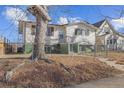 House exterior showcasing a tree and chain link fence at 4170 Chase St, Denver, CO 80212