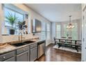 Kitchen with gray cabinets, stainless steel appliances, and a dining area at 9519 E 107Th Pl, Commerce City, CO 80640