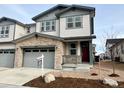 Two-story townhome with attached garage and landscaping at 6594 N Malta St, Aurora, CO 80019