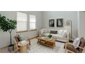Living room features a light-colored sofa, two armchairs, and a coffee table at 15453 E 109Th Ave, Commerce City, CO 80022
