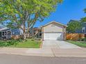 Charming ranch home with a well-manicured lawn and attached garage at 3597 E 134Th Dr, Thornton, CO 80241