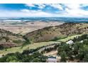 Breathtaking aerial view of property with expansive mountain views and landscape at 6057 Red Hill Rd, Boulder, CO 80302