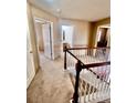 Upper hallway with carpet, doors to bedrooms and bathroom, and staircase at 21030 E 39Th Ave, Denver, CO 80249
