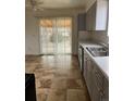 Kitchen with double sink, stainless steel appliances, and tile floor at 15552 E Temple Pl, Aurora, CO 80015