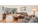 Living room featuring hardwood floors, neutral furniture, and a coffee table at 3225 W Scott Pl, Denver, CO 80211