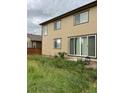 House back with sliding glass doors leading to backyard at 25605 E Maple Pl, Aurora, CO 80018