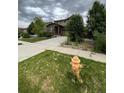 Two-story house with a front yard and driveway at 25605 E Maple Pl, Aurora, CO 80018