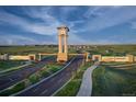 Entrance to The Aurora Highlands community with a clock tower and landscaping at 23931 E 40Th Ave, Aurora, CO 80019