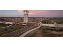 Entrance to The Aurora Highlands community with a clock tower and landscaping at 23931 E 40Th Ave, Aurora, CO 80019