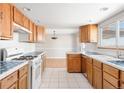 Galley kitchen with wood cabinets and blue tile at 3889 Pikes Peak Rd, Parker, CO 80138