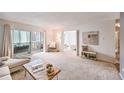 Living room with access to patio and view of bedroom at 660 S Alton Way # 7A, Denver, CO 80247