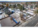 An aerial view showcasing a house with a large yard, detached garage, and surrounding neighborhood at 6101 S University Blvd, Centennial, CO 80121