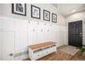 Bright entryway with bench, coat hooks, and wood-look floors at 23263 E Costilla Pl, Aurora, CO 80016