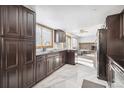 Modern kitchen with dark cabinets and marble floor at 5895 S Killarney Way, Centennial, CO 80015