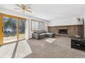 Living room with fireplace and sliding glass door at 5895 S Killarney Way, Centennial, CO 80015