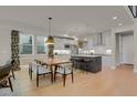 Modern kitchen with white cabinets, island, and stainless steel appliances at 30 S Oneida St, Denver, CO 80230
