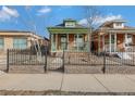 Charming brick home with a green porch, showcasing curb appeal at 756 Kalamath St, Denver, CO 80204