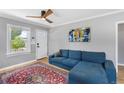 Living room with blue sectional sofa and red rug at 1454 Rosemary St, Denver, CO 80220