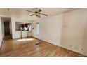 Living room with hardwood floors and view into kitchen at 3512 N High St, Denver, CO 80205