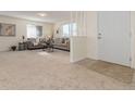 Spacious living room with neutral carpeting and comfy seating at 9812 Lane St, Thornton, CO 80260