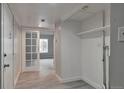 Clean hallway with french doors opening to a living area and storage at 9995 E Harvard Ave # 179, Denver, CO 80231
