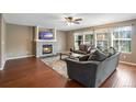 Spacious living room with hardwood floors, a fireplace, and large windows at 1160 Cardinal Ave, Brighton, CO 80601